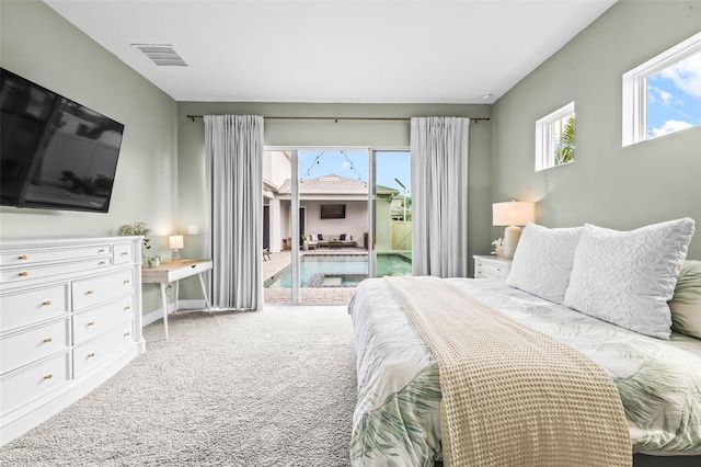 bedroom with access to exterior, multiple windows, visible vents, and carpet flooring