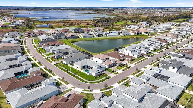 drone / aerial view featuring a water view and a residential view