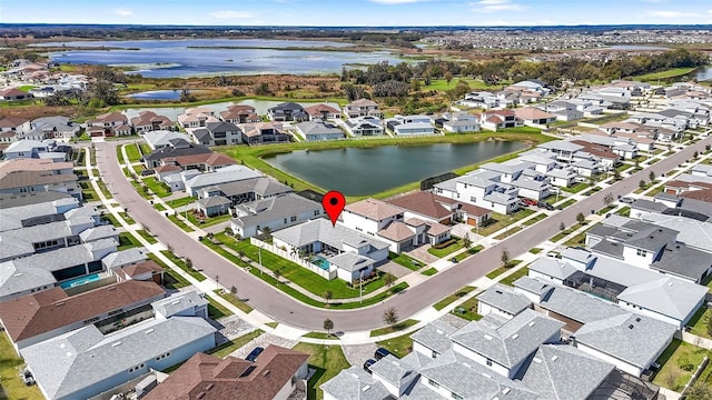 bird's eye view with a water view and a residential view