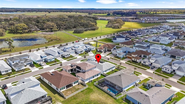 drone / aerial view featuring a water view and a residential view