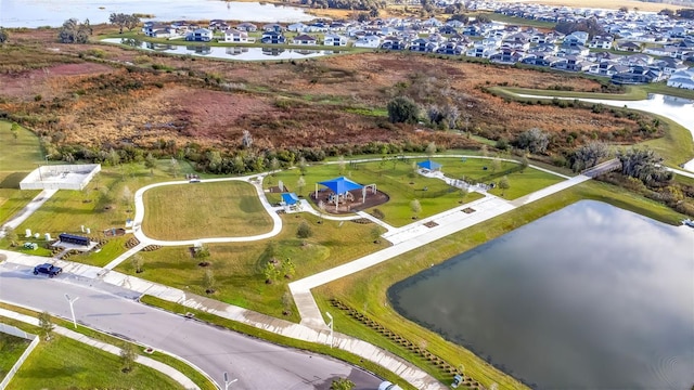 drone / aerial view with a water view and a residential view