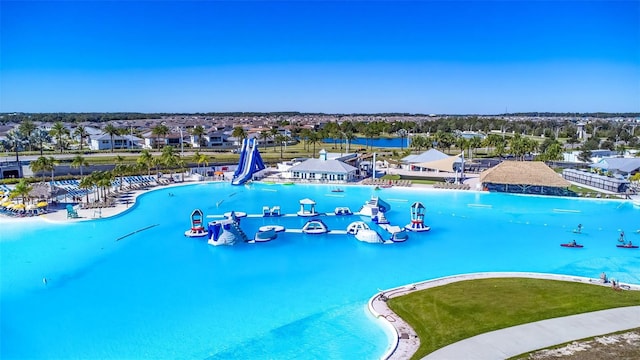 view of swimming pool with a water view, a residential view, and a water slide