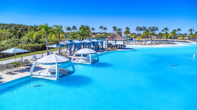 pool with a patio area and a water play area