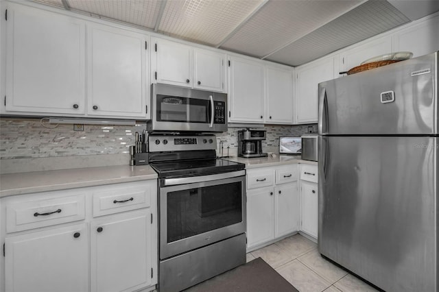 kitchen with white cabinetry, stainless steel appliances, and light countertops