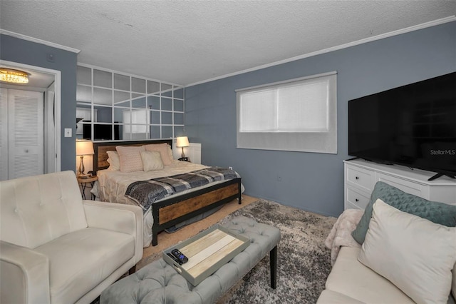 bedroom with a textured ceiling and crown molding