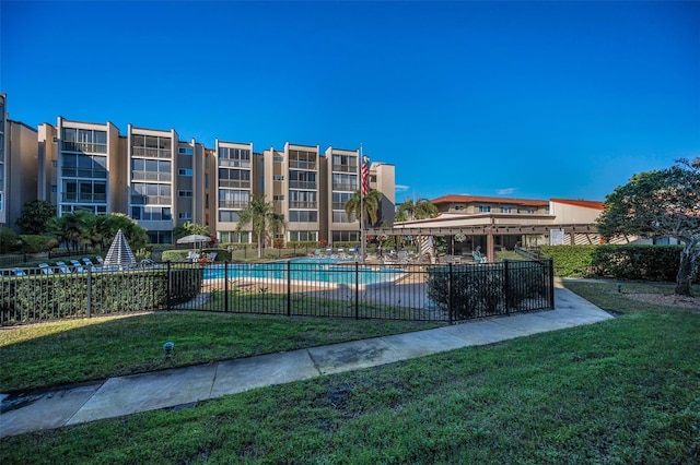 pool featuring a yard and fence