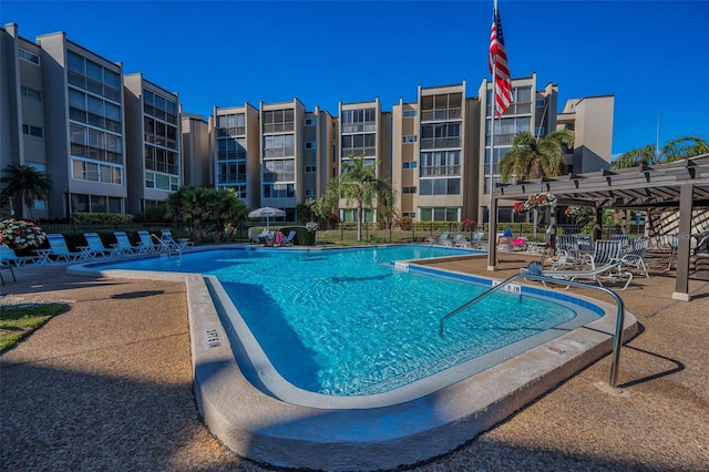 community pool featuring a patio area and fence