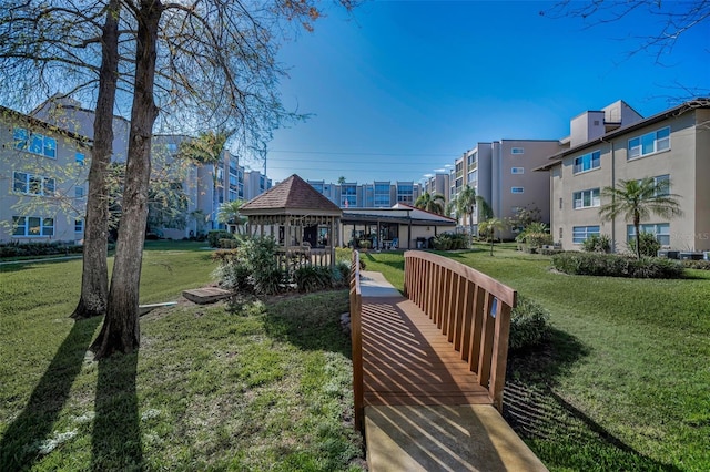 view of home's community with a lawn and a gazebo