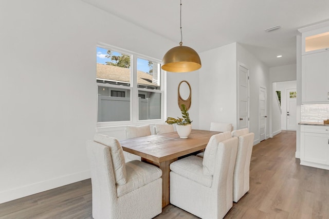 dining space with recessed lighting, visible vents, baseboards, and wood finished floors