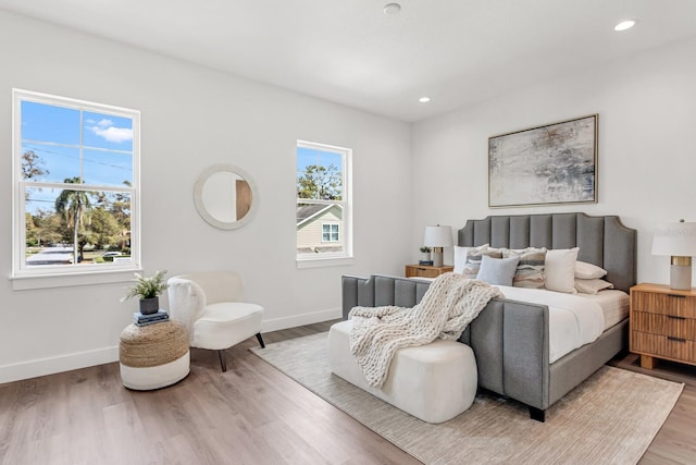 bedroom featuring baseboards and wood finished floors