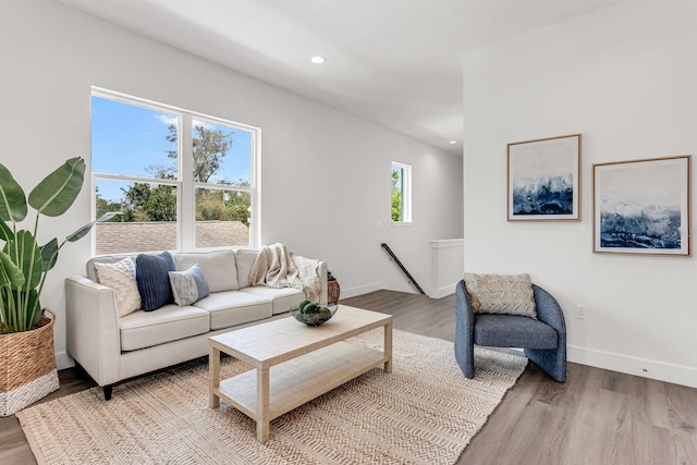 living area with recessed lighting, baseboards, and wood finished floors