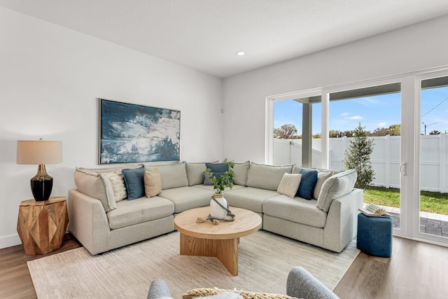 living area featuring recessed lighting, light wood-style flooring, and baseboards