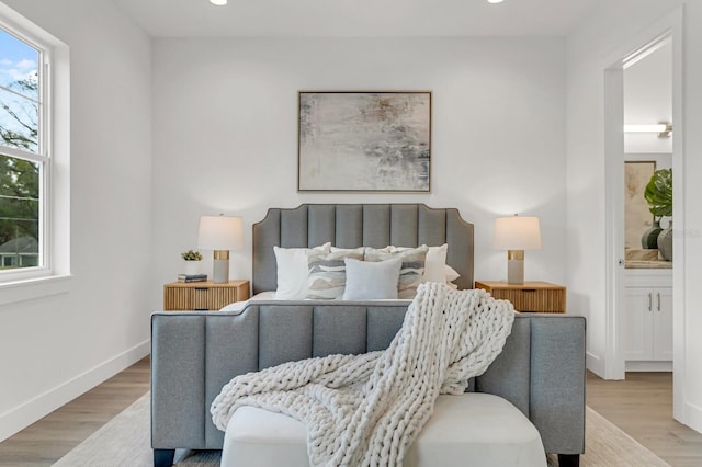 bedroom featuring recessed lighting, wood finished floors, connected bathroom, and baseboards