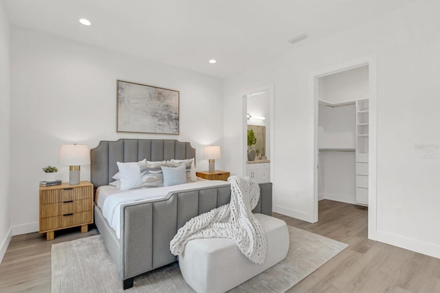 bedroom with light wood-style floors and baseboards