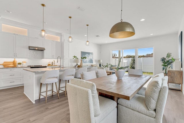 dining room with recessed lighting, visible vents, and light wood-style flooring