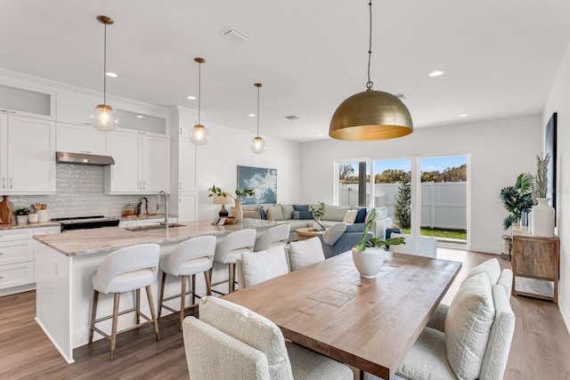 dining area featuring light wood-type flooring, visible vents, and recessed lighting