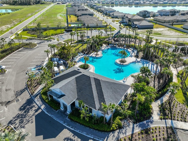 drone / aerial view featuring a water view and a residential view