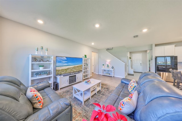 living room with recessed lighting, visible vents, baseboards, and stairs