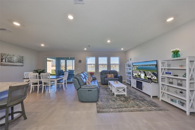 tiled living room featuring visible vents and recessed lighting