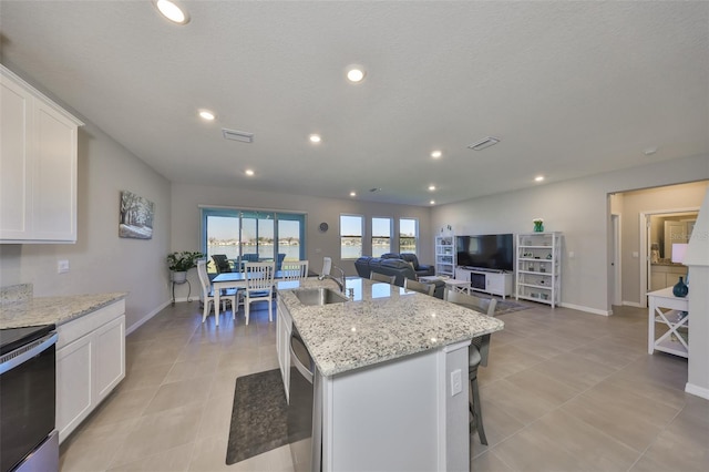 kitchen featuring white cabinets, a sink, electric range, and stainless steel dishwasher