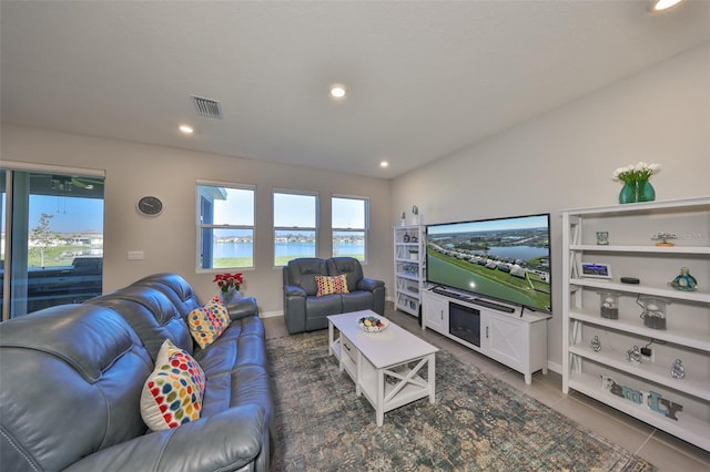 living area featuring recessed lighting, visible vents, and tile patterned floors