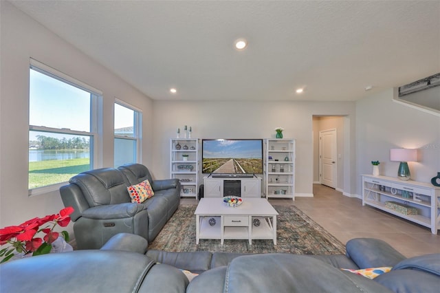 tiled living room featuring baseboards and recessed lighting