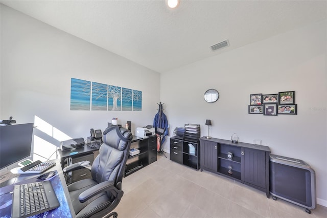 office area with light tile patterned floors, visible vents, and a textured ceiling