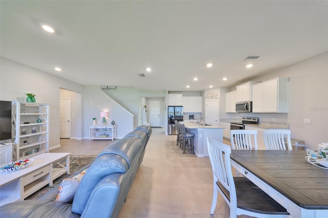 living area featuring visible vents and recessed lighting