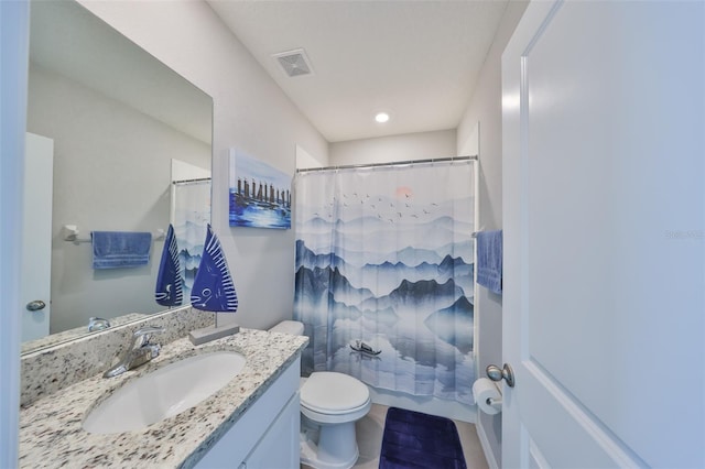 bathroom with toilet, visible vents, and vanity