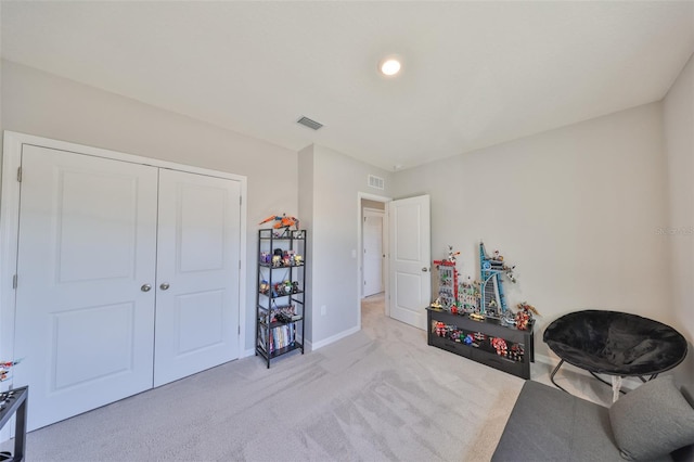 living area with light carpet, visible vents, and baseboards