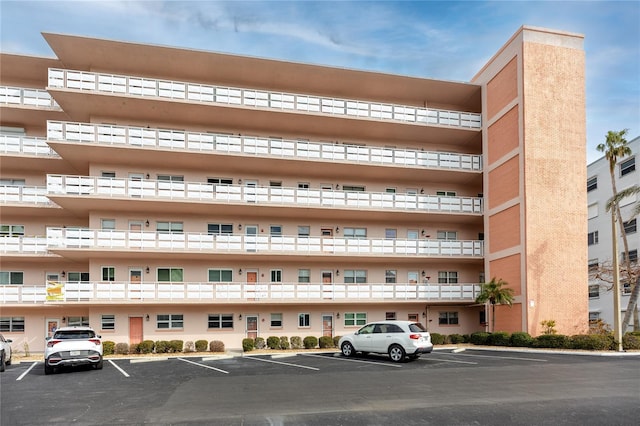 view of building exterior featuring uncovered parking