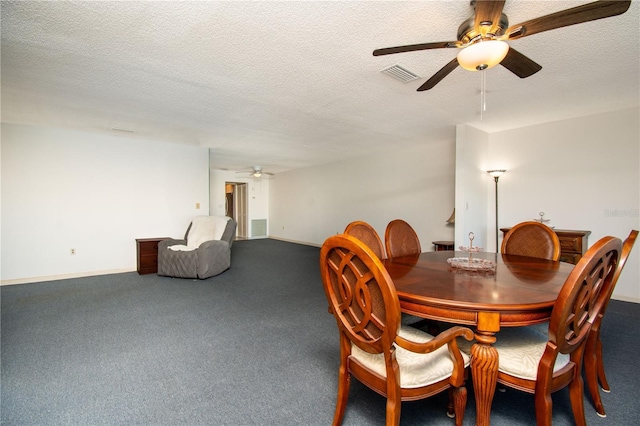 dining area featuring a ceiling fan, visible vents, a textured ceiling, and carpet flooring