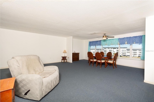 living area with a ceiling fan, carpet, and a textured ceiling