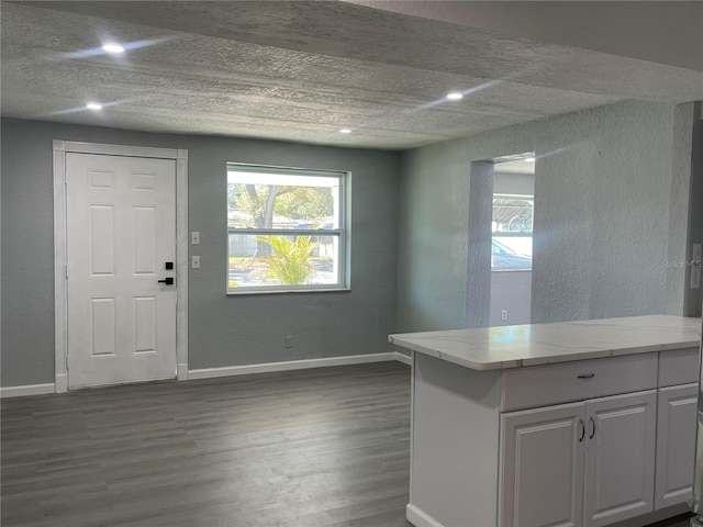 entrance foyer with dark wood-style floors, baseboards, and recessed lighting