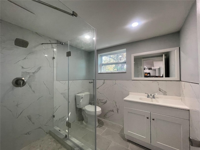 full bath with toilet, vanity, tile walls, marble finish floor, and a marble finish shower