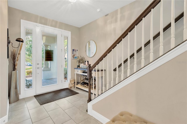 foyer with tile patterned flooring and stairway