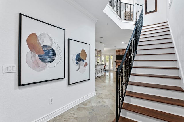 stairs with ornamental molding and baseboards