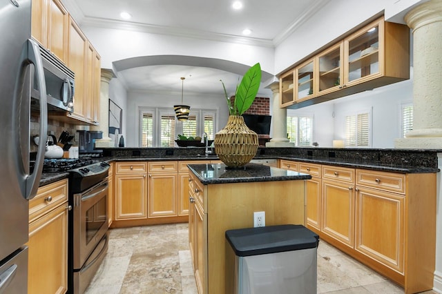 kitchen featuring a peninsula, a kitchen island, arched walkways, and stainless steel appliances