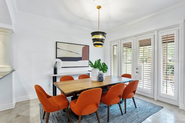 dining space featuring ornate columns, baseboards, crown molding, and french doors