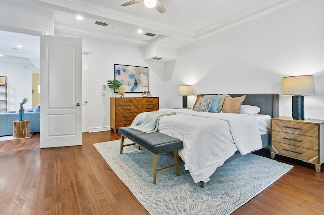 bedroom with recessed lighting, visible vents, crown molding, and wood finished floors