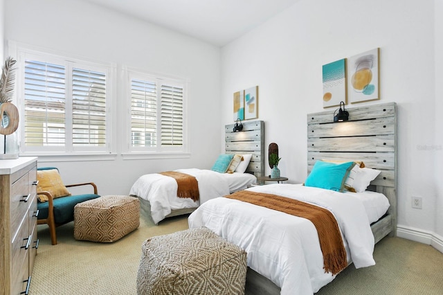 bedroom featuring carpet and baseboards