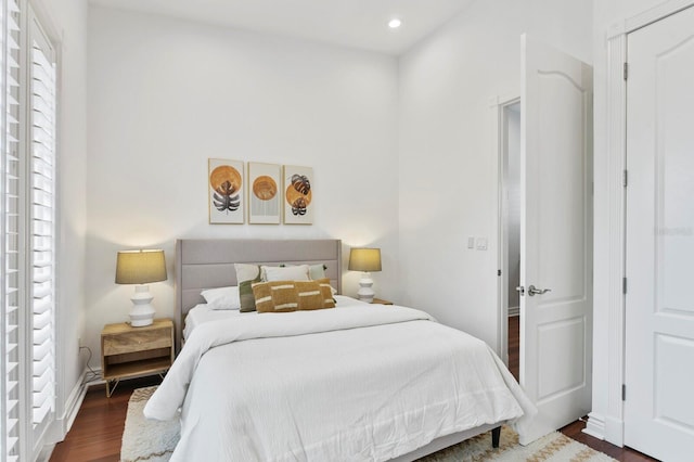 bedroom featuring baseboards, wood finished floors, and recessed lighting