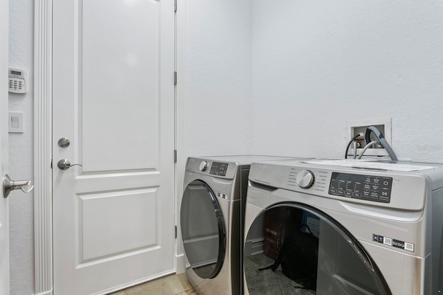 laundry area with laundry area and washer and clothes dryer