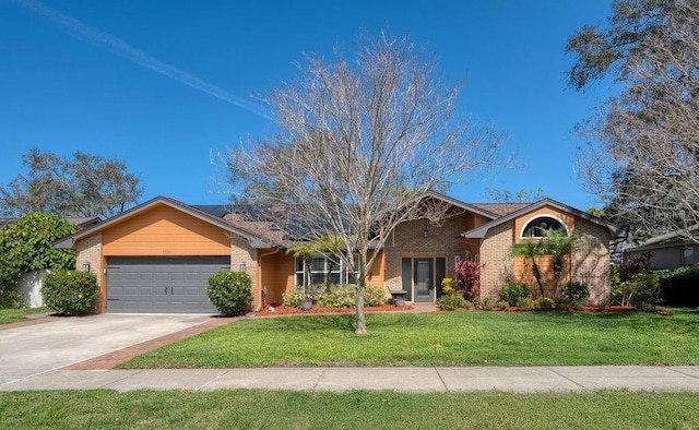 single story home with driveway, brick siding, a front lawn, and an attached garage