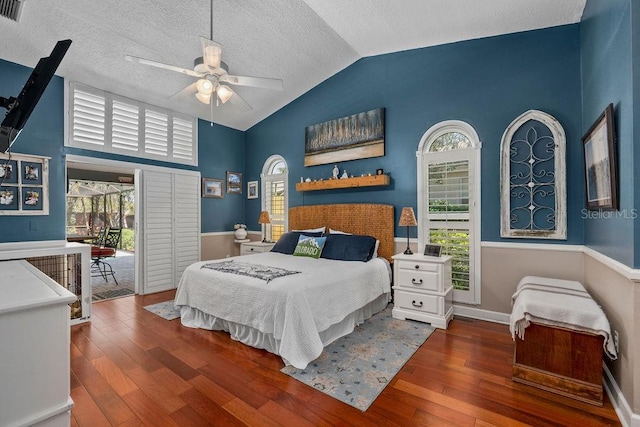 bedroom featuring vaulted ceiling, a textured ceiling, baseboards, and hardwood / wood-style flooring