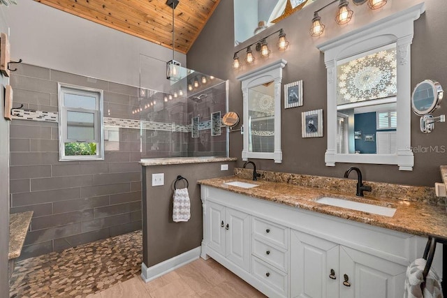 full bath featuring double vanity, walk in shower, a sink, and wood ceiling