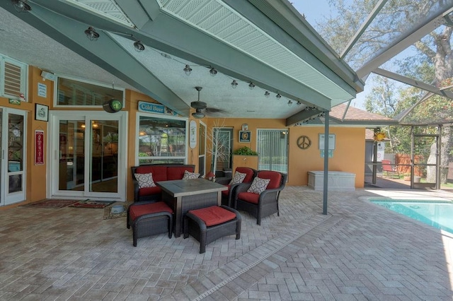 view of patio / terrace with an outdoor hangout area, ceiling fan, a lanai, and an outdoor pool