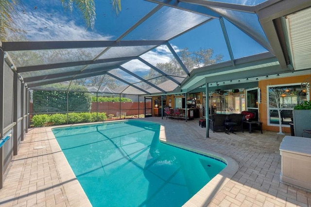 view of swimming pool with a lanai, a patio area, and a fenced in pool