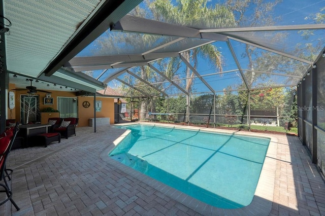 pool featuring a patio area and glass enclosure