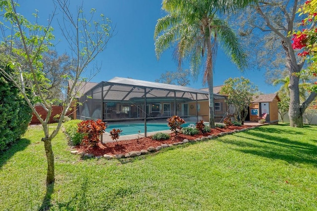 back of house with glass enclosure and a yard